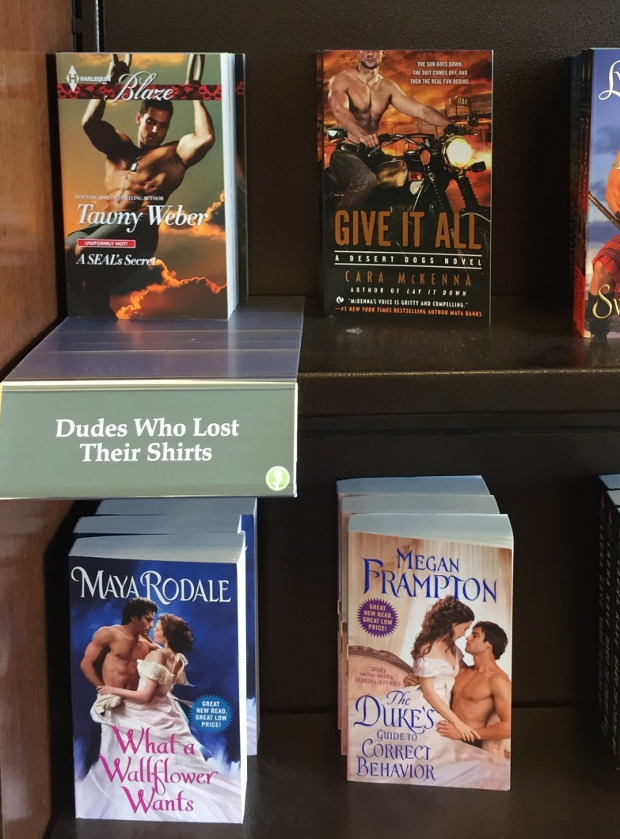 bookstore display with the kind of romance covers where men are shirtless