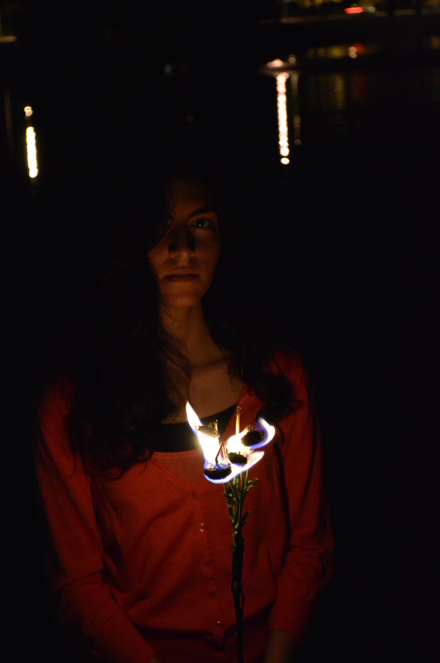 Maryam holding burning yellow flowers