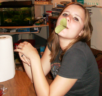 Alicia using two green Pringles to make duck lips