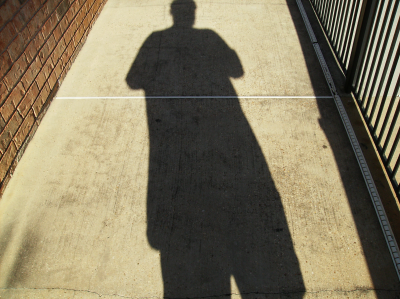 Doug's shadow on the ground at Fontainbleu Apartments