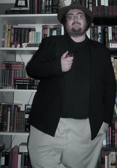 Doug with his pipe, standing in his library