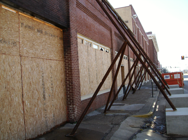 Metal struts against side of building