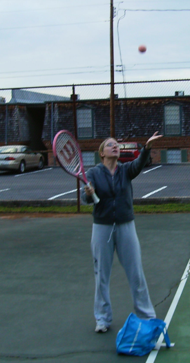 Sarah getting ready to hit a ball as it goes up